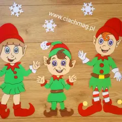 Trzy uśmiechnięte elfy w zielonych strojach i czerwonych czapkach, gotowe do świątecznych przygotowań. Jak zrobić elfa?